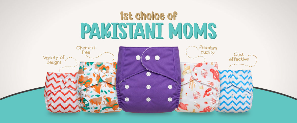 Five reusable cloth diapers displayed side by side on a teal and white background, with the text '1st choice of PAKISTANI MOMS' above them. The center diaper is purple, and the surrounding diapers show different printed patterns in orange, green, red, and blue.